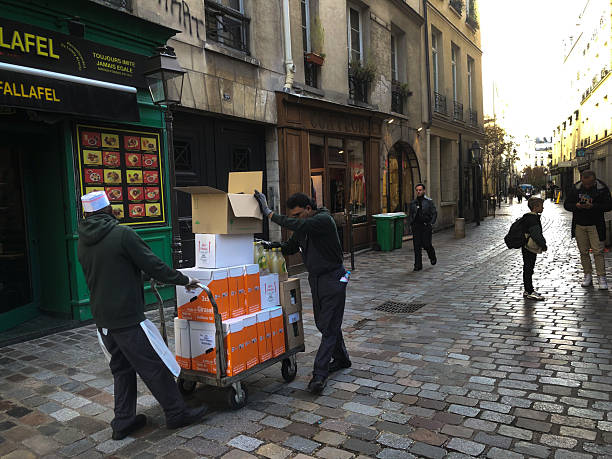 Paris, France - October 30, 2025: Construction workers outside a cookie shop just off rue des Rosiers in the Marais.
