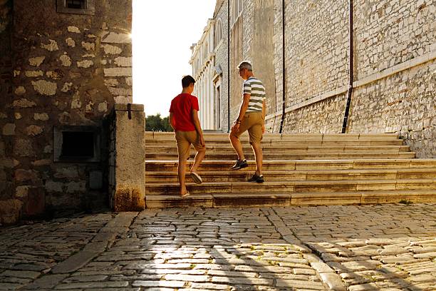 Photo of a smiling little boy sharing spending some quality time with his father in the city