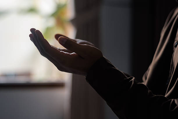 istock Side View of Muslim Man's Hands Raised in Prayer During Ramadan 2261036500