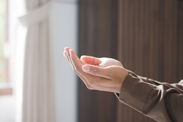 istock Side View of Muslim Man's Hands Raised in Prayer During Ramadan 2261036543