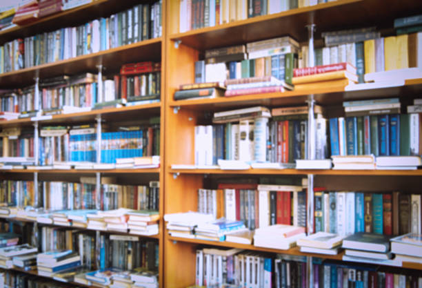 blurred bookshelf in library for your background design