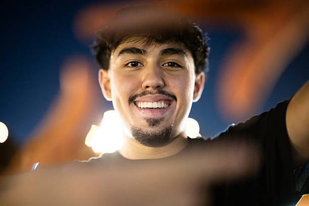 Gen Z friends skateboarding and doing tricks, street skating, at night