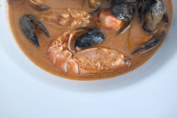 A high-resolution photo of assorted fresh seafood including prawns, scampi (langoustines), mussels, and clams. The ingredients are presented raw and arranged naturally, ideal for themes like seafood cuisine, fresh ingredients, Mediterranean diet, and coastal cooking.