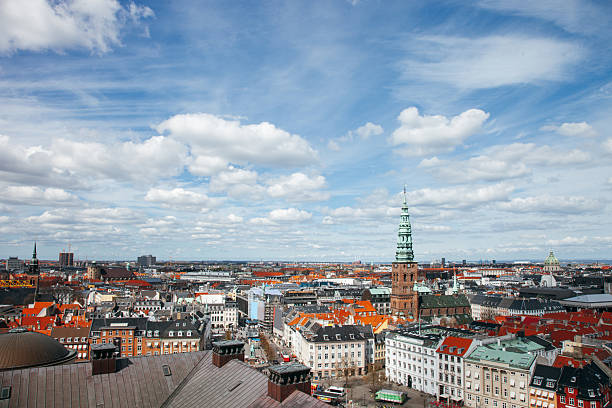 Wide cityscape views show Copenhagen from above, revealing rooftops, historic buildings, and the layered structure of the city. The images communicate scale, urban density, and the blend of old and modern architecture typical of a Northern European capital.
