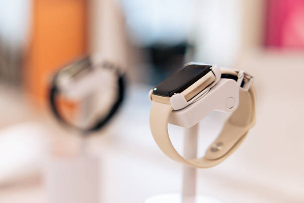 Close-up view of a smartwatch displayed on a counter in a modern electronics store. Wearable technology showcased on a demo stand, highlighting product design, consumer electronics, and retail presentation.