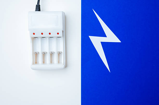 Fourslot Charger On Split Blue And White Background, Indicator Lights Glowing, USB Cable Attached,