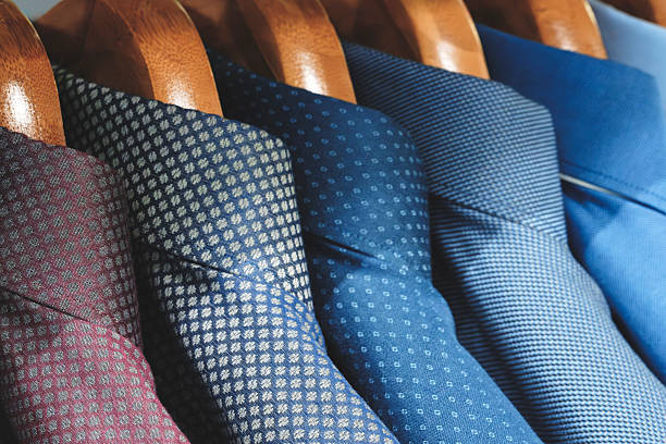 A handsome African American businessman shopping for ties at a clothing store.