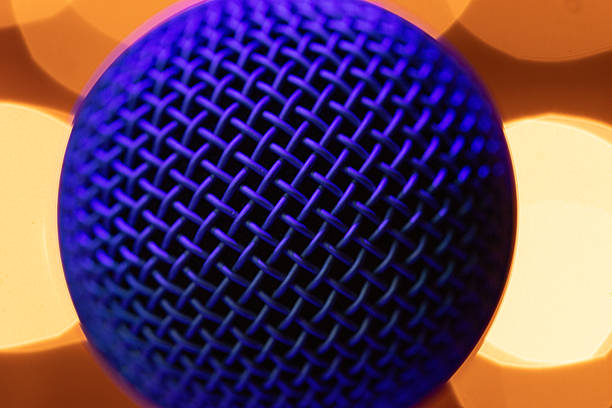 Professional Vocal Microphone with Blue Lighting on Warm Golden Bokeh Background