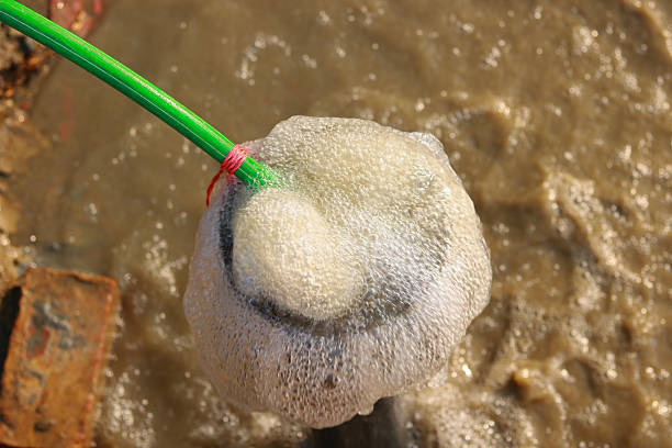 Close-up of frothy white foam during water pump testing or well cleaning process