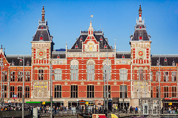 Netherlads, Amsterdam - November 3, 2024: Amsterdam Central Station during the day, on the river bank.