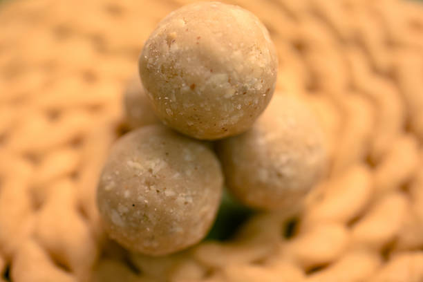 Snack balls made from natural ingredients are placed on a woven plate. The setting suggests healthy eating.
