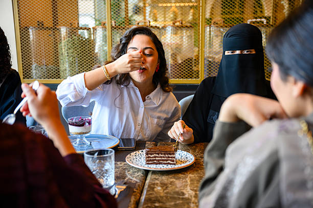 Group of friends enjoying desserts at cafe