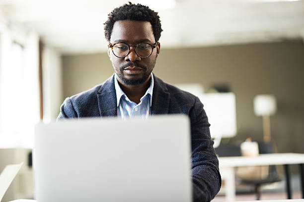 istock Focused businessman working on laptop in modern office 2261126777