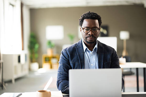 istock African american businessman working on laptop in modern office 2261126780