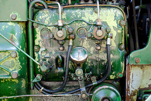 Old, oil-smeared engine block of a tractor