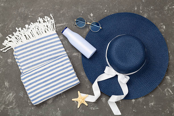 Blue beach accessories on concrete background, top view. Flat lay