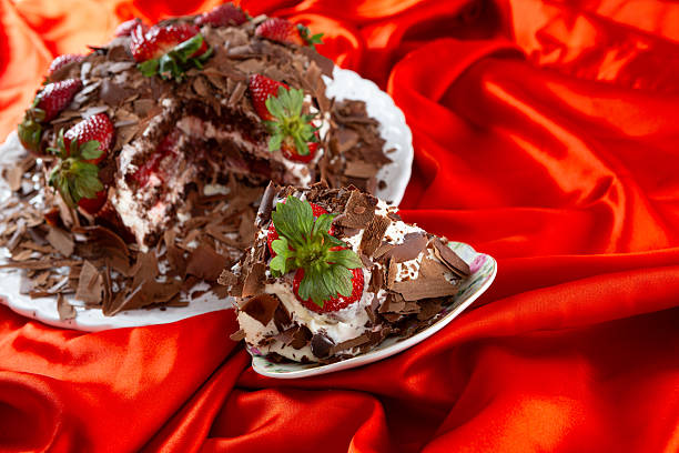 An individual serving of tart presented on a luxurious red satin backdrop, emphasizing a sophisticated and indulgent dessert.