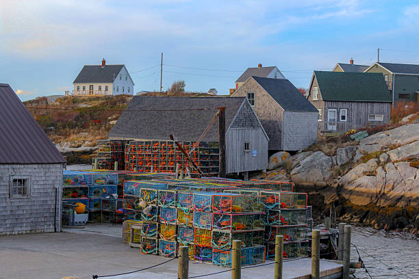 Peggy's Cove, Canada - November, 2025: Sunset at the Peggy's Cove Lighthouse, in the famous fishing town with the same name. It's located in the maritime province of Nova Scotia, on Canada's East Coast. Nowadays Peggy’s Cove is considered a major tourist attraction in the Maritimes.