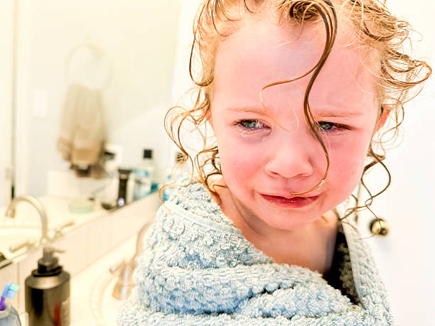 Young child crying and throwing a tantrum in the bathroom