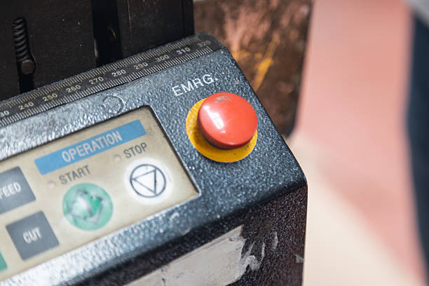 Stop Button and the Hand of Worker About to Press it. emergency stop button. Big Red emergency button isolated on white background.