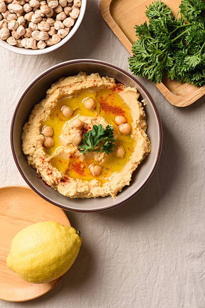 Homemade creamy hummus with olive oil and chickpeas in a ceramic bowl