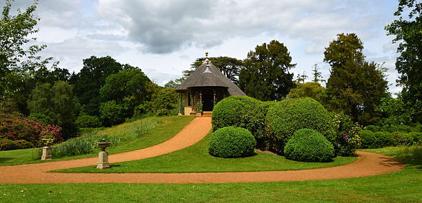 Ickwell, Bedfordshire, England - May 30, 2025: Thatched Garden Summer house on small hill in garden