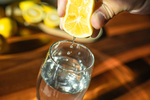 Man adding lemon juice to water