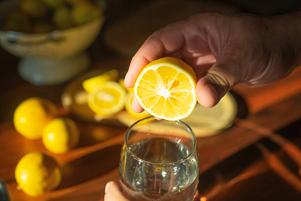 Man adding lemon juice to water