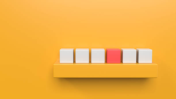 Front view of 6 elegant 3D white and 1 unique leader expert cubes different red standing out from the rest on bright vibrant yellow luxury background with copy space. Apt for concept of uniqueness, expertise, differently abled, inclusiveness, diversity, blend or fit in.