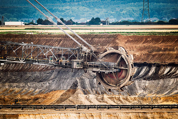 Large bucket-wheel excavator in a brown coal open-pit mine, showcasing heavy machinery used in surface mining
