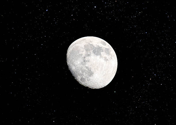 Astronomical photograph of a bright full moon surrounded by a dense field of stars in the night sky. The moon is captured with clear surface detail, including visible craters and maria, while the surrounding stars vary in brightness and create a vivid celestial backdrop. The dark sky enhances the contrast between the illuminated lunar surface and the surrounding space. This image is ideal for nature portfolios, astrophotography collections, educational use, or stock imagery focused on astronomy and night‑sky observation.