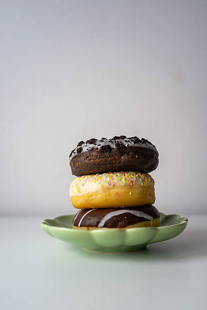 Stacked donuts on plate An eyecatching and lively donut arrangement with vivid decorations for multiple