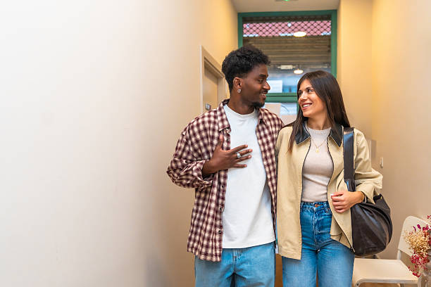istock Diverse young couple smiling, walking together, sharing a moment 2261243656