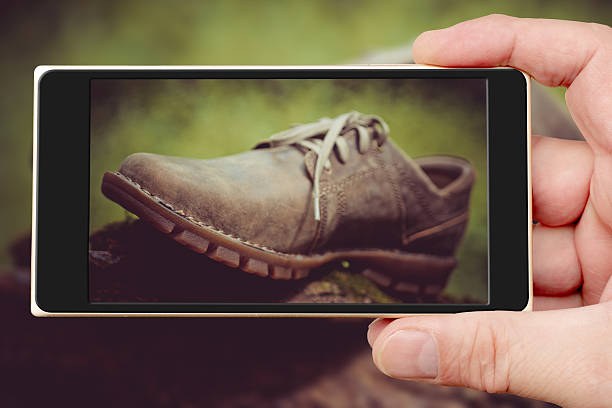 Shoes on smartphone screen. New stylish brown mens shoes.