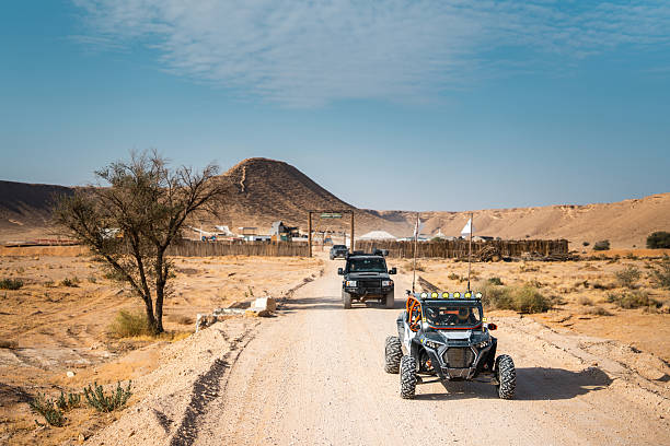 A group of 4x4 campers set up camp among the sand dunes of the Adrar desert region in the Mauritanian Sahara
