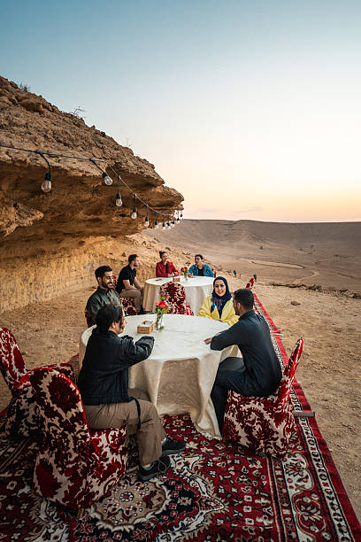Diverse Tourists Enjoying Evening Meal at Ghamra Camp Cave Restaurant