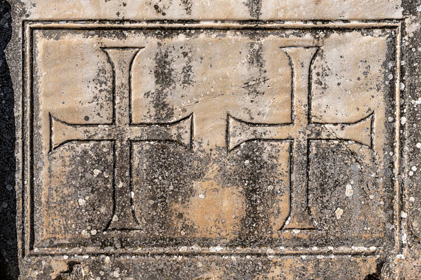 Carved cross relief displays Christian symbol with decorative frame on marble panel at Ephesus, Turkey. The detailed carving shows characteristic Byzantine Christian iconography with the cross motif prominently displayed. The religious carving represents Ephesus's transformation into Christian center after Constantine, when the city became important early Christian site associated with St. John and the Virgin Mary, with Christian symbols replacing pagan imagery on monuments, demonstrating the religious transformation that saw Ephesus evolve from center of Artemis worship to major Christian pilgrimage destination.