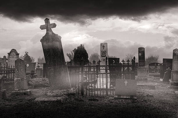 Old cemetery covered in mist on a stormy winter day.