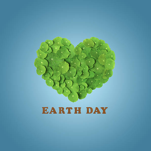 Earth day 2026 concept and green recycling. Mockup of heart is made of green leaf and an inscription made of wooden letters on blue background. Ecology concept. World Environment Day