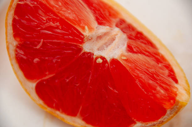Two whole red grapefruits