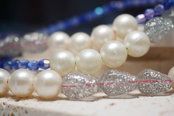 Colorful beaded necklaces are creatively arranged on a surface.