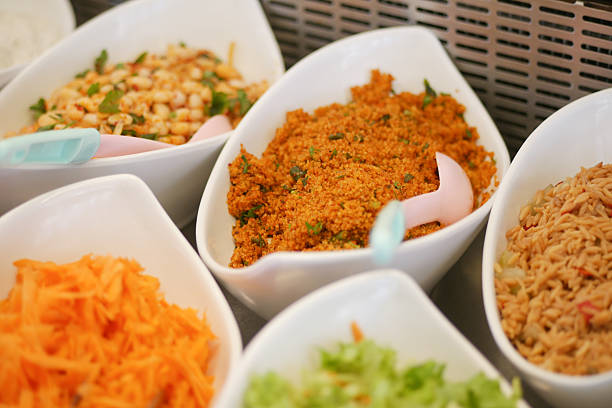 A vibrant display of fresh salads and sides at a buffet gathering.