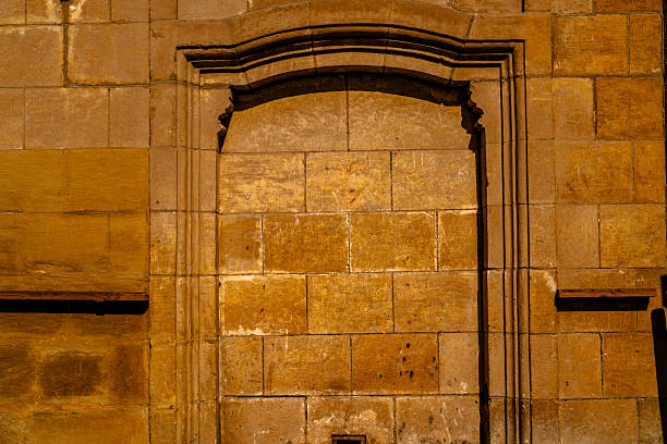 Frontal view of an ancient stone doorway with arched architecture in Giza, Egypt, featuring warm tones, weathered texture, and historic character ideal for heritage, design, and travel concepts.