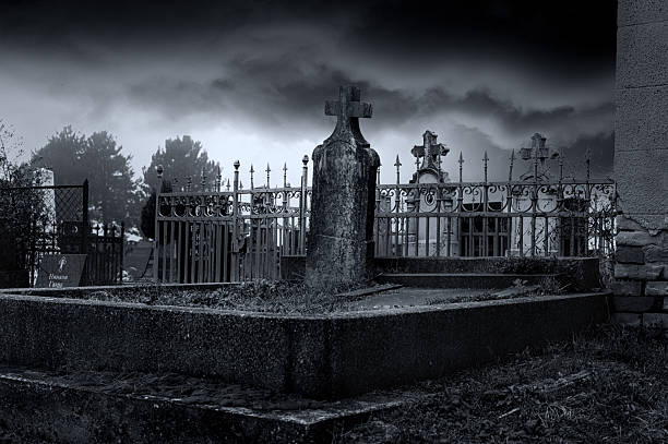 Old cemetery covered in mist on a stormy winter day.