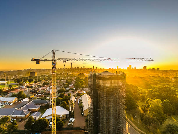 Water Tower Under Construction seen here at sunrise with silhouette background of Johannesburg cityscape.
