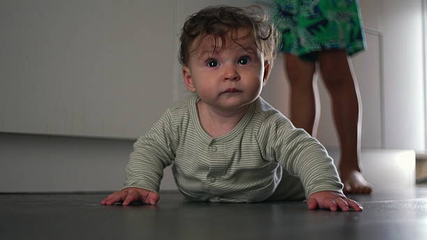 istock Baby crawling on kitchen floor exploring surroundings with curiosity and determination home life moment of growth and discovery 2261305200
