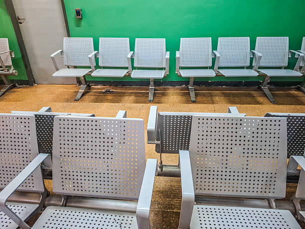 red waiting chairs in front of white wall