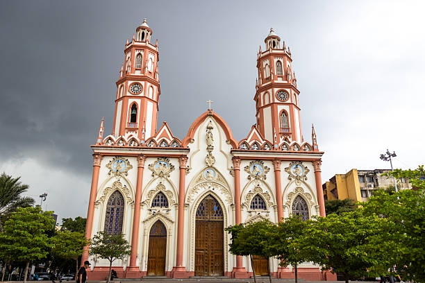 View of the historic red brick neo-gothic facade and twin towers of San Nicolas Church at the public square in the historic center of Barranquilla, Colombia.