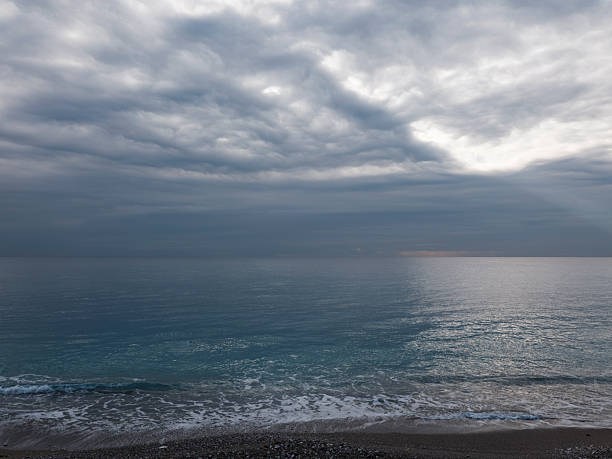 Moody sky with rain clouds over seascape