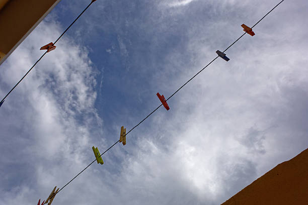 abstraction, ropes with colored clothespins with the sky in the background